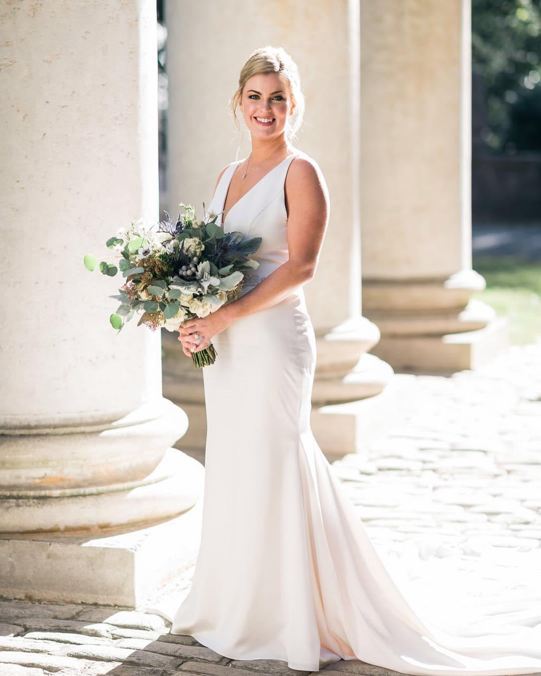 Luxury bride portrait among grand stone columns