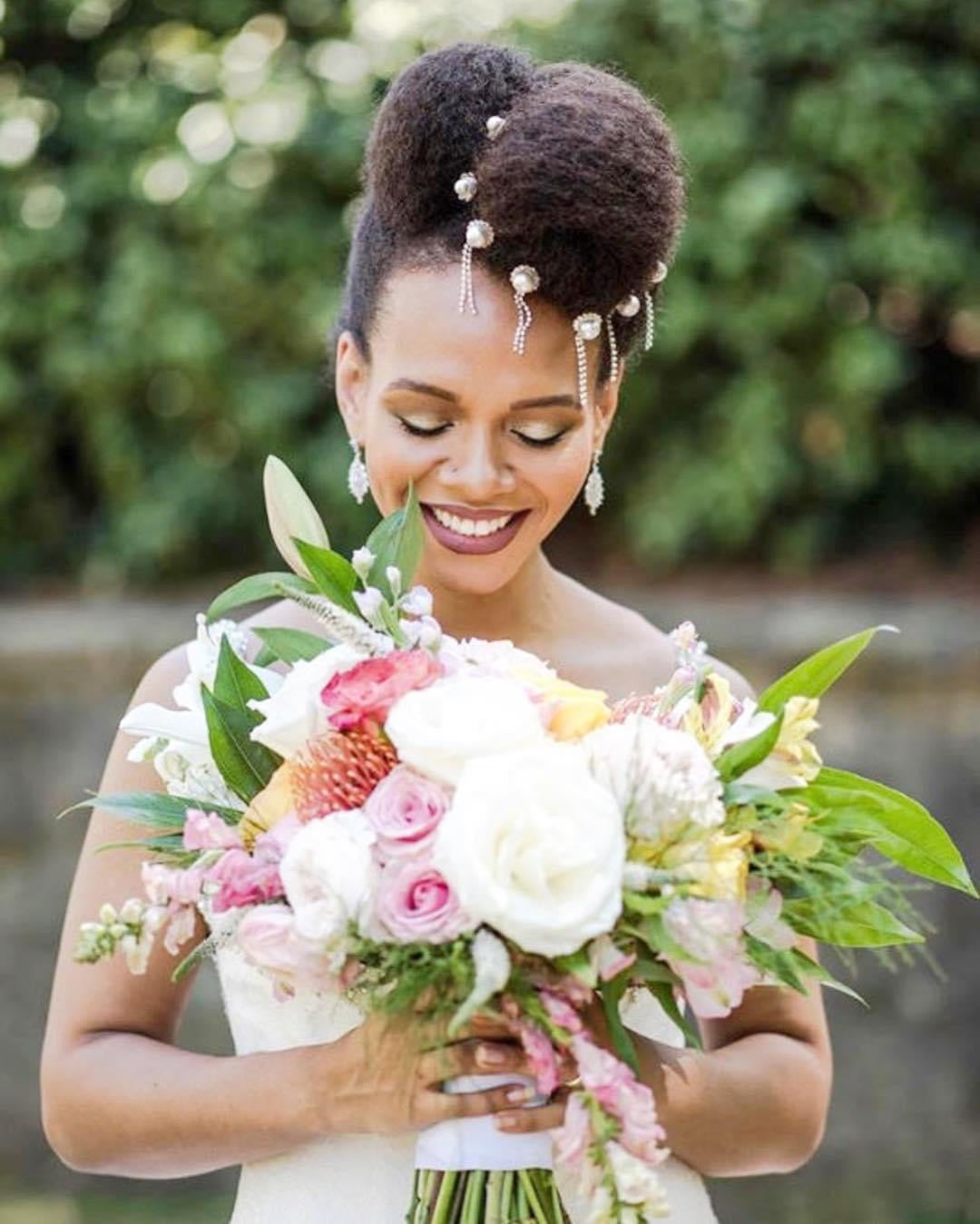 Bold bridal beauty with natural hair pearl pins and berry lip