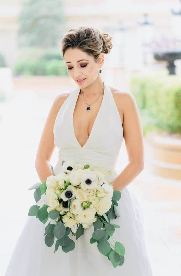 Elevated romantic bridal glam with emerald jewelry and anemone bouquet
