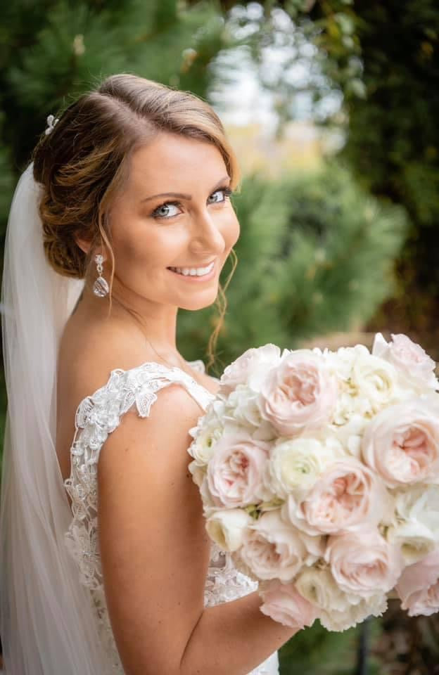 Romantic bride with garden roses over-the-shoulder portrait