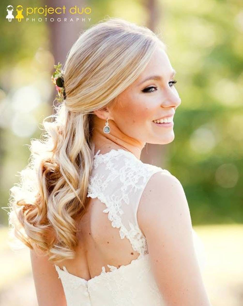 Romantic bridal profile with flowing curls and lace gown