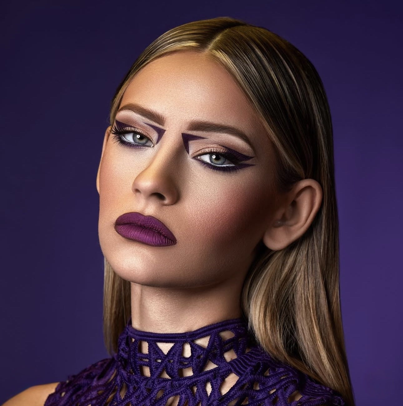 Purple graphic eyeliner and deep purple lip commercial editorial