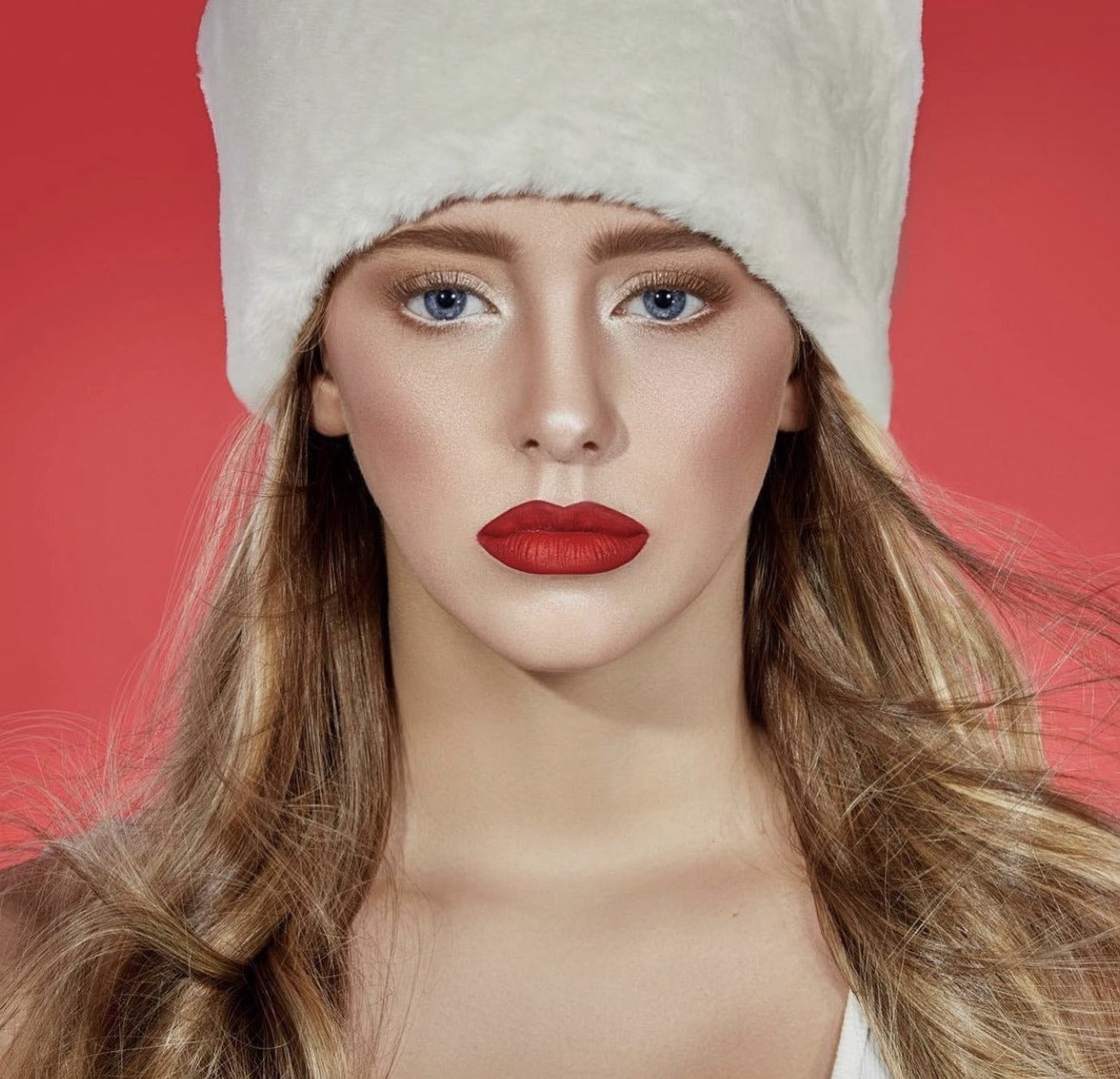 Holiday editorial with white fur hat and bold red lip